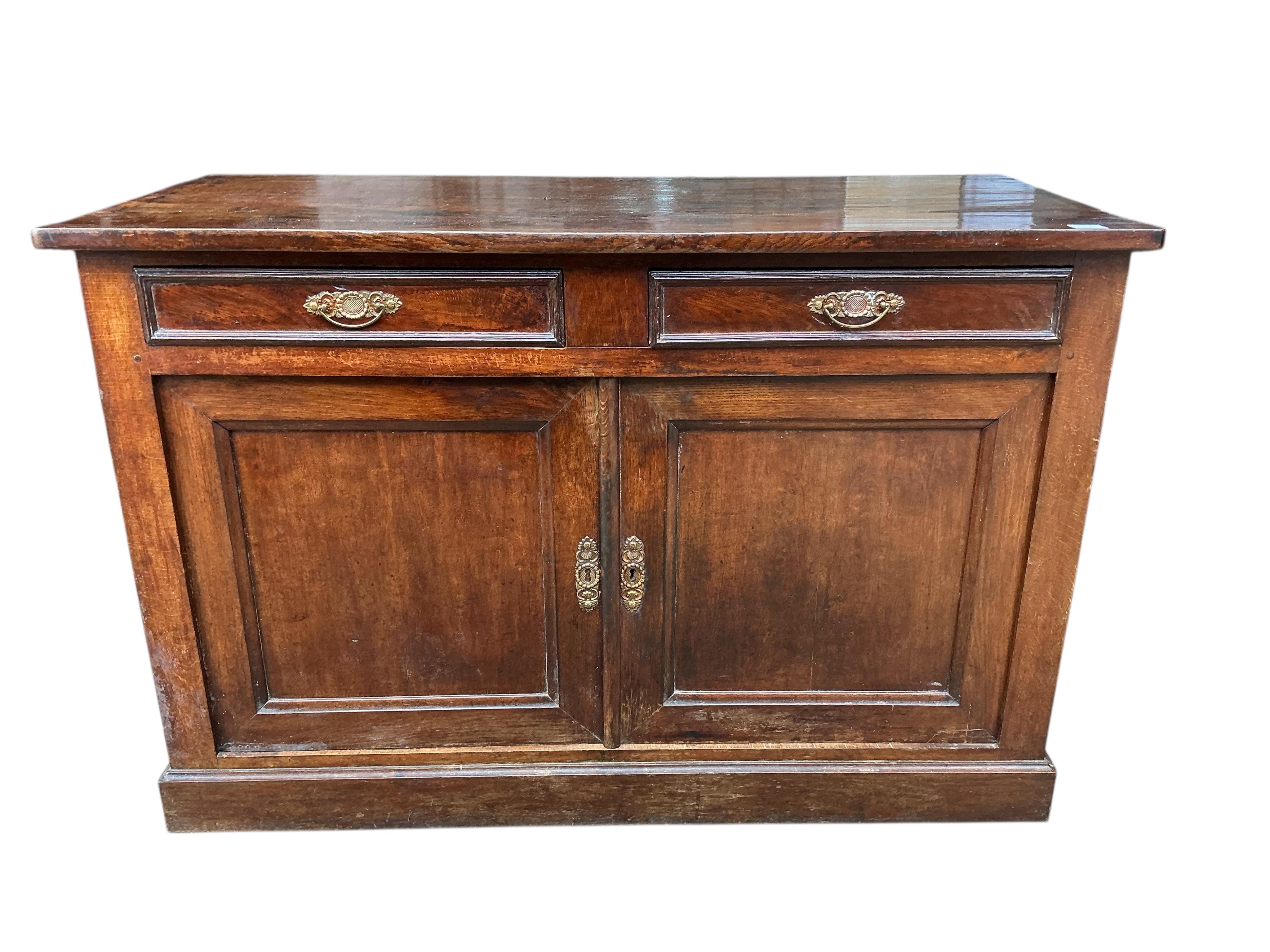 An early 19th century French oak and fruit wood buffet, width 140cm, depth 62cm, height 92cm